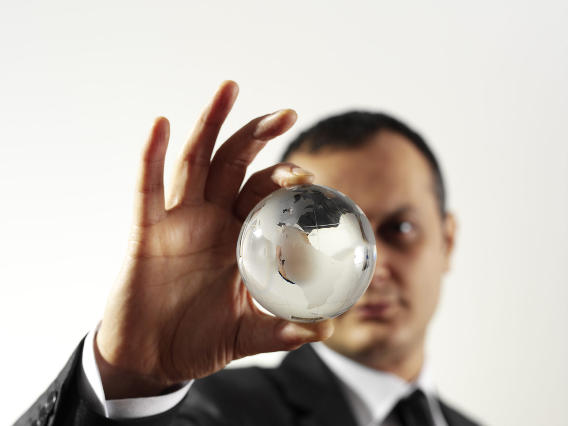 businessman holding glass globe