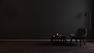 Dark minimalist space with reading book and candles. Business Impact article image for leaders and entrepreneurs in focus: Nicky Story, supplies for candles.