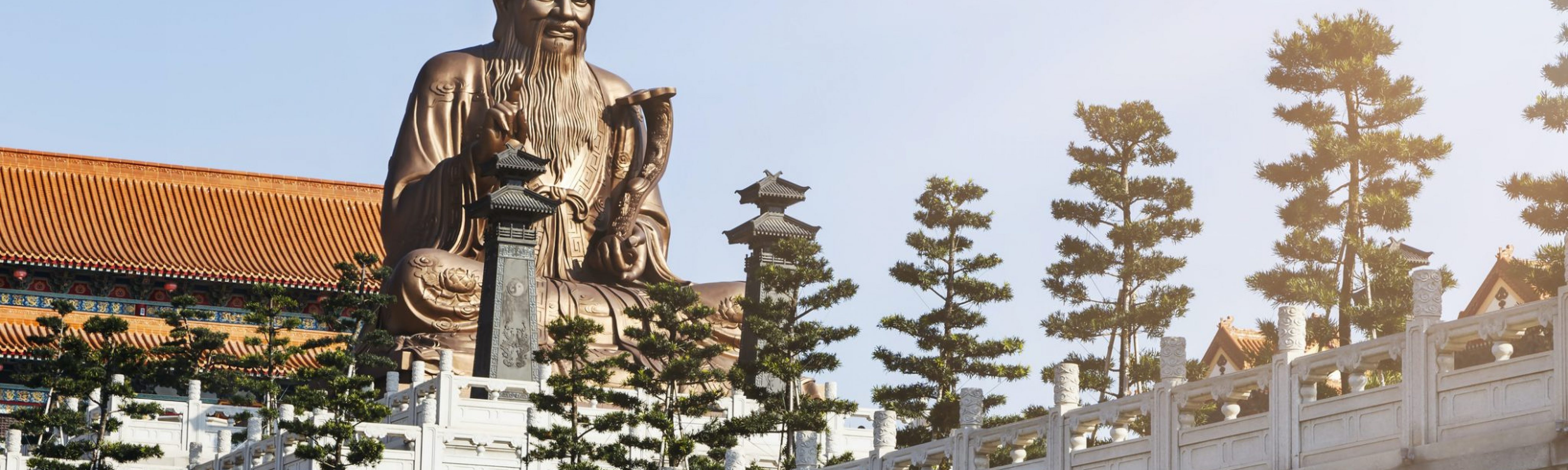 A Chinese statue on top of a temple inspired building in Laozi, China symbolic philosophy of life and leadership